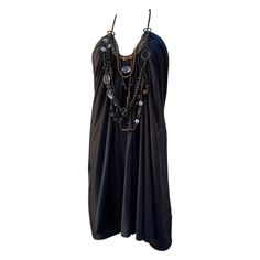 This dress is one of our favorite listings. The design by KaufmanFranco was loved by the fashion editors worldwide. The dress itself is beautiful, draped front black silk with hand beaded gold metal detail. What transcends the dress to spectacular is a group of Metal, wood, crystal beads and embellishment that drape beautifully on the front of the dress. The dress is held at the neck by an antique gold chain that has a lovely clear crystal that hangs on the back f the neck. Our fashionista clien Silk Jewelry, Metal Detail, Draped Dress, Fashion Editor, Hand Beading, Black Silk, Clear Crystal, Silk Dress, Antique Gold