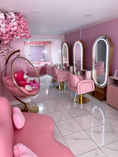 a room filled with lots of pink furniture and mirrors