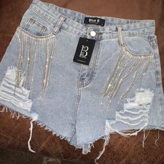 Rhinestone Light Wash Shorts Trendy High Waisted Embellished Bottoms, Trendy High Waist Embellished Bottoms, Glamorous Summer Denim Bottoms, High Waist Jean Shorts With Rhinestone Fringe For Party, High Waist Bottoms With Rhinestone Fringe For Summer, Party High-waist Jean Shorts With Rhinestone Fringe, Trendy Rhinestone Bottoms For Night Out, High Waist Bottoms With Rhinestones For Night Out, Party Shorts With Rhinestone Fringe