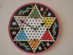 a clock that is on the wall and has different colored dots all over it's face