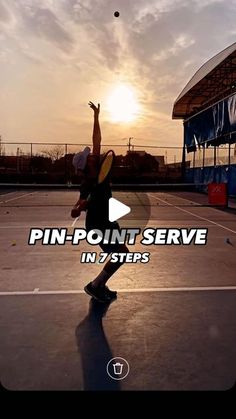 a person on a court with a tennis racket and ball in the air above their head