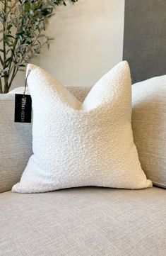 a white pillow sitting on top of a couch