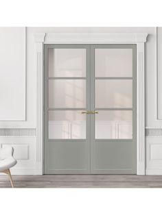 a white chair sitting in front of a door with two glass panels on each side