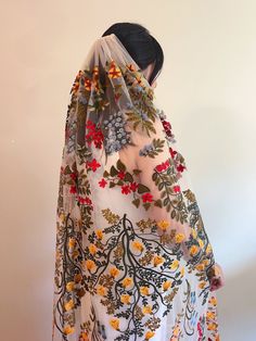 a woman wearing a veil with flowers on it