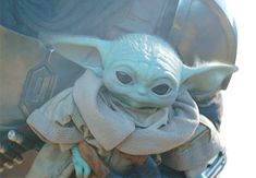 the baby yoda is wearing a robe