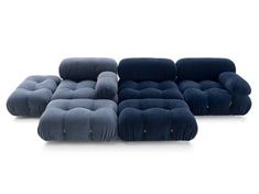 four different types of blue and grey velvet sofas, one with buttons on the back