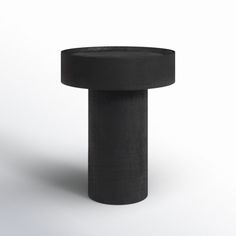 a black round object sitting on top of a white surface