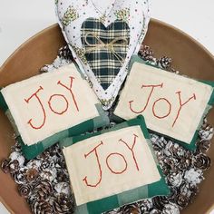 three handmade christmas ornaments in a bowl