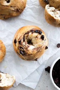 some type of pastry with raisins and chocolate chips on the table next to it