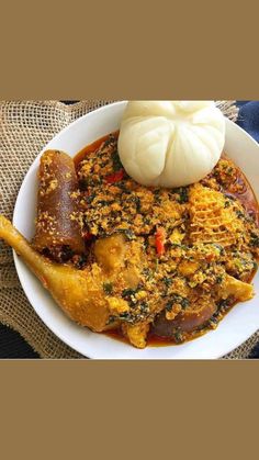 a white bowl filled with food on top of a table