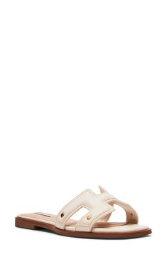 Exude breezy style in this easy-wear slide sandal fashioned with a square open toe, studded faux-leather strap and flat sole. Synthetic upper and lining/rubber sole Imported Cream Slip-on Slides For The Beach, Trendy White Leather Slides, Cream Slip-on Slides For Summer, Cream Open Toe Slides For Beach, Modern Beige Slides For The Beach, Modern Beige Slides For Beach, White Casual Slides With Single Toe Strap, Trendy Beige Slides With Removable Insole, Cream Slides For Vacation In Spring