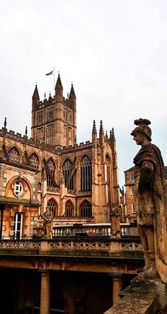 an old building with statues in front of it