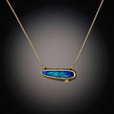 This vibrant necklace features a magical Australian opal, accented with a twinkling diamond dot. The stones are wrapped in 22k gold, backed with sterling silver, and float on a 14k gold chain. Pendant measures approximately 3/4" wide. Matte finish. Each stone is unique and may vary slightly from image. Luxury Metal Necklaces With Stones, Luxury Turquoise Opal Jewelry, Luxury One-of-a-kind Opal Jewelry, Opal Stone Necklaces, Opal Necklace Goddy, Luxury Opal Jewelry With Gemstone Accents, Luxury Opal Jewelry With Accent Stones, Luxury Formal Opal Necklaces, Luxury Opal Necklaces With Gemstone Accents