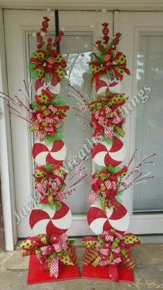 the letter o is made out of candy canes and bows on display in front of a door