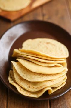 a plate full of tortillas on a wooden table