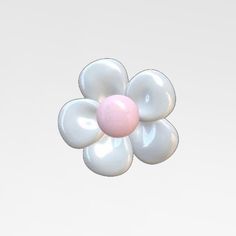 a pink and white flower shaped object floating in the air