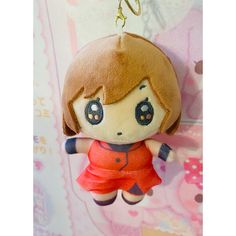 a keychain with a doll hanging from it's side on a wall