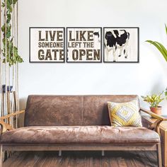 a living room with a couch and two pictures on the wall above it that says live like someone left the gate open