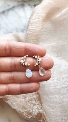 Our crescent moon and moonstone drops are the ultimate boho galaxy lovers dream! #bohemianstyle #moonstonejewelry #bridaljewelry #wanderandlustjewelry Elegant Crescent Moonstone Jewelry, Elegant Moon Shaped Cubic Zirconia Earrings, Elegant Moon-shaped Wedding Earrings, Elegant Moon Shaped Wedding Earrings, Moon-shaped Crystal Earrings With Moon Charm As Gift, Crystal Moon Earrings With Moon Charm As Gift, Moon Shaped Crystal Earrings With Moon Charm As Gift, Gift Crystal Moon Earrings With Moon Charm, Elegant Half Moon Earrings With Moon Charm