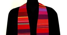 a black mannequin wearing a multicolored scarf