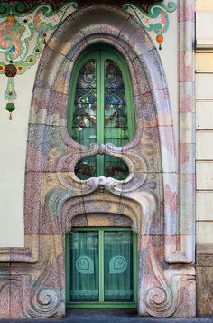 an art nouveau door with stained glass windows