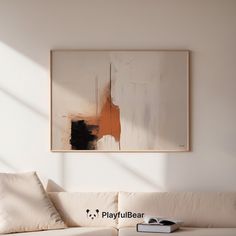 a living room with a white couch and painting on the wall