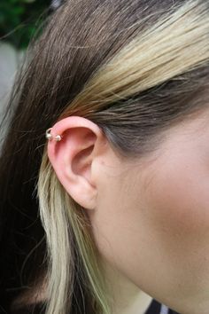 a close up of a person wearing an ear piercing