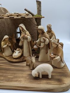 a nativity scene with figurines and a goat