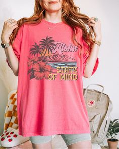 Aloha State of Mind, Aloha Tshirt, Aloha T Shirt, Aloha Shirt/Hawaii T Shirt/Beach Shirt/Vacation Shirts/Hawaii Gifts/Hawaiian Gifts/Summer Gifts Crafted from lightweight cotton that is perfect for active wear or leisure, our Aloha State of Mind shirt offers comfort and style. It's ideal for casual wear, whether going to work, grabbing coffee with friends, or just wanting to wear a comfortable shirt during daily activities. Whether you're curled up on the couch, on the beach, or simply lounging Pink Palm Tree Print Short Sleeve Top, Pink Summer Hawaiian Shirt With Relaxed Fit, Pink Tropical T-shirt For Summer, Pink Relaxed Fit Hawaiian Shirt For Summer, Beachy Hawaiian Shirt With Relaxed Fit, Beachy Hawaiian Shirt With Short Sleeves, Relaxed Fit, Beachy Hawaiian Shirt With Relaxed Fit And Short Sleeves, Pink Hawaiian Camp Shirt For Beach, Pink Summer Camp Shirt For Beach