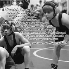 two women sitting on top of a wrestling mat with words written in front of them