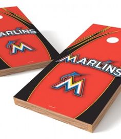 two red and black cornhole game boards with the word marlins on each one side