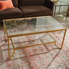 a living room with a couch, coffee table and rug