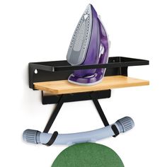 an ironing board with a green circle next to it and a black rack holding two electric irons