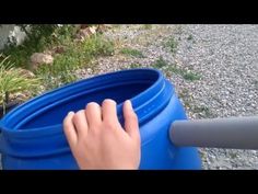 someone is holding onto the handle of a blue barrel