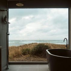 a bath tub sitting in front of a large window