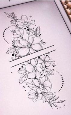 some flowers on top of a piece of paper next to a pen and ink drawing