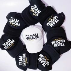 a group of hats with the word groom written on them in black and white colors