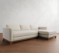 a white couch sitting on top of a wooden floor