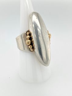 "Vintage Artisan Sterling Silver Oblong Ring with 14k Gold Accent -Very nicely made, handcrafted, artist signed -Large Sterling silver elongated lens shape with 14k gold bubble accents on each side -Ring is open at the shank, could be slightly adjusted in size if desired -Ring is size 8.25 -Ring is hallmarked \"Sterling\" \"14k\" and has an artists hallmark with a snake in the shape of a M or triangular wave -Ring face measures about 1.5\" x .75\" with a depth of .4\" -Total weight 11.8g -In goo Modern Oblong Jewelry For Anniversary, Modernist Oval Gold Jewelry, Oblong Jewelry With Polished Finish For Anniversary, Handmade Modernist Oval Rings, Modernist Hallmarked Oval Jewelry, Modernist Oval Gold Rings, Unique Polished Oval Rings, Handmade Wide Band Rings For Formal Events, Handmade Wide Band Rings For Formal Occasions