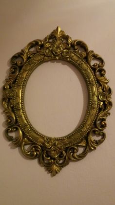 an ornate gold frame hanging on the wall