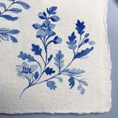 a blue and white floral print on a piece of paper