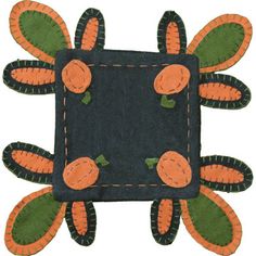 an orange and black patchwork design with carrots on it