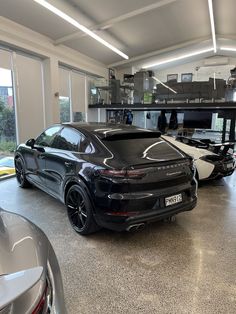 two porsche cars parked in a garage next to each other with open windows on both sides