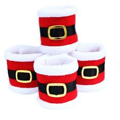 four red and white santa claus boots with gold buckles on each boot, all lined up together