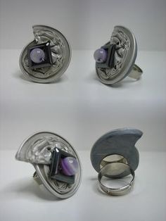 four different types of silver rings with purple stones