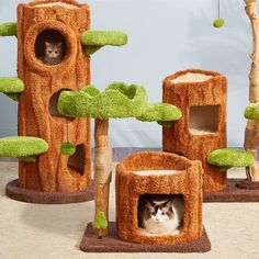 two cats are sitting in their cat tree houses, one is green and the other is brown