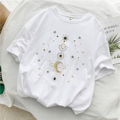 a white t - shirt with an image of the moon and stars on it