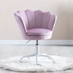 a purple office chair sitting on top of a white rug in front of a wall