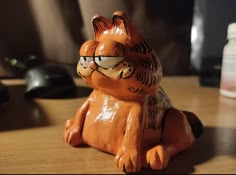 a ceramic cat with glasses sitting on a table