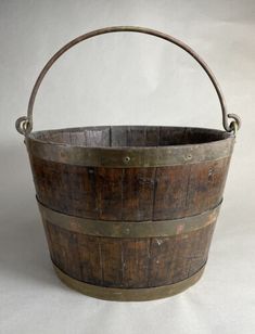 an old wooden bucket with metal handles